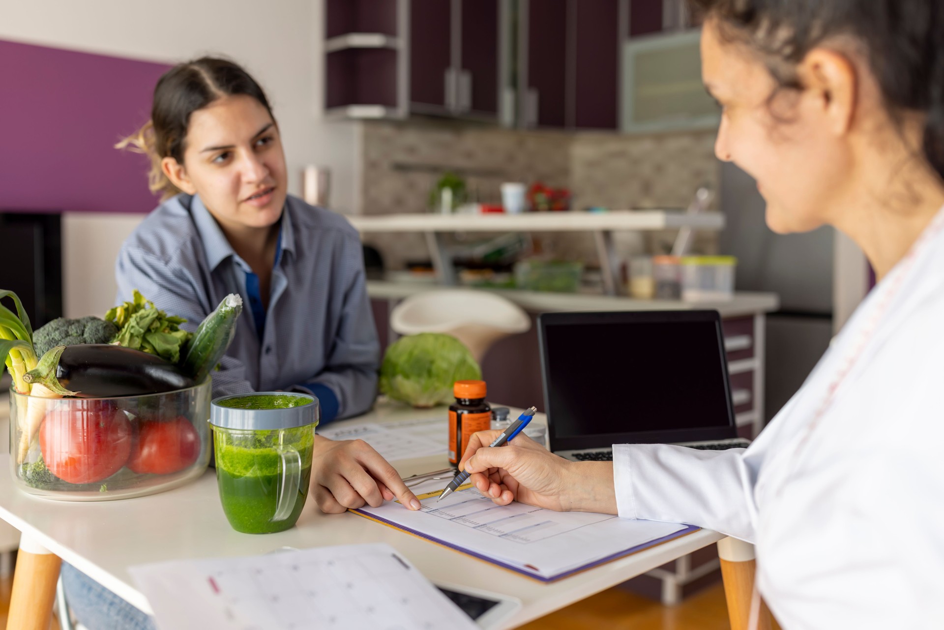 Female doctor nutritionist, dietician and her patient on consultation in the office.
