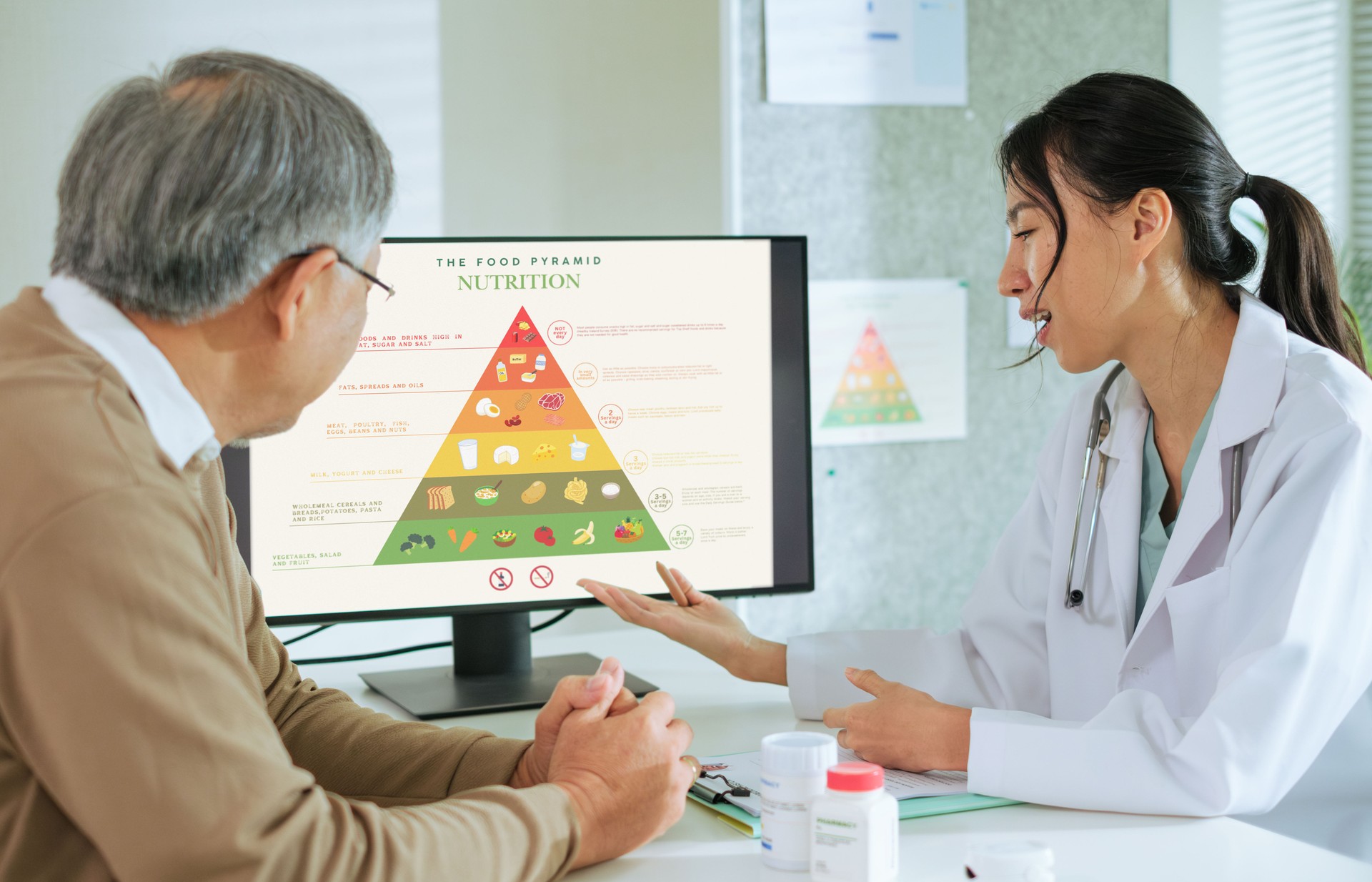 Doctor Explaining Healthy Eating and Food Pyramid to Senior Patient During Nutrition Counseling